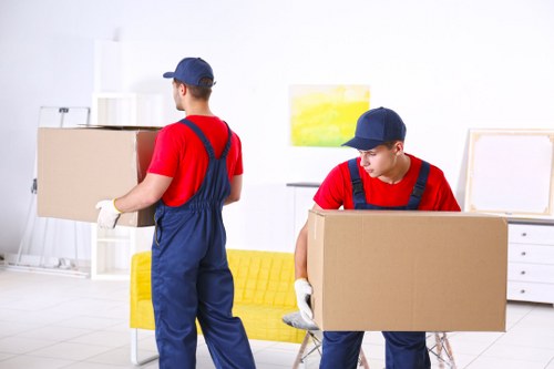 Professional movers handling office furniture and equipment