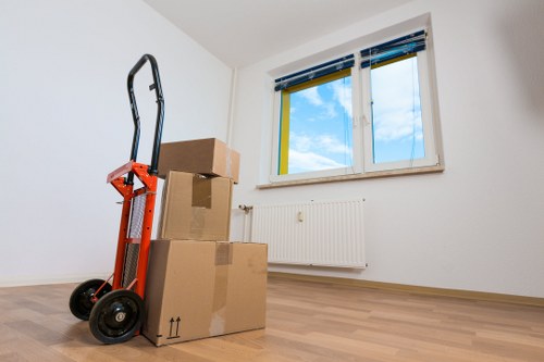 Professional movers packing office equipment